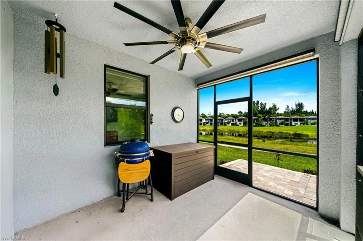 Sunroom featuring a water view, a patio area, and a ceiling fan