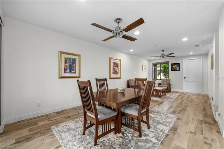Dining space with light wood finished floors, recessed lighting, and a ceiling fan