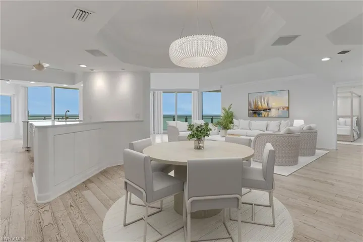 VIRTUAL STAGED Dining room with light wood-type flooring, a chandelier, a ceiling fan, and recessed lighting