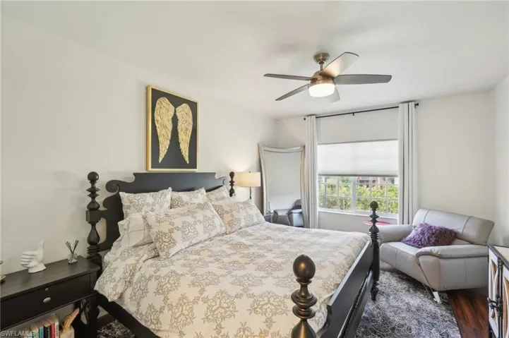 Bedroom with a ceiling fan and dark wood-style floors