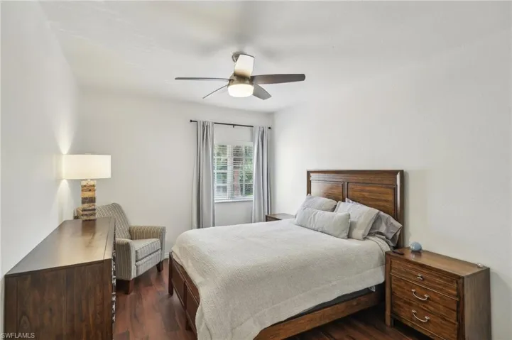 Bedroom featuring a ceiling fan and dark wood-style floors
