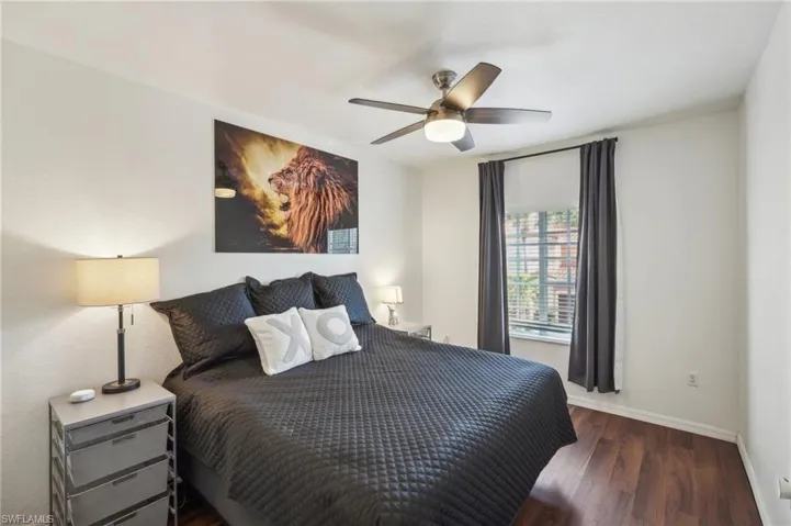 Bedroom featuring baseboards, wood finished floors, and ceiling fan