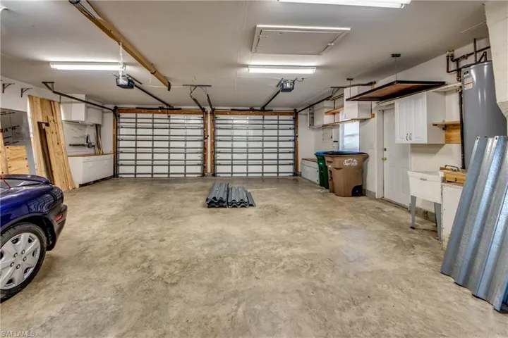 Huge Newer Garage w/ 3 doors, Refrigerator, Many cabinets & Work Stations. Large Floored Attic above.