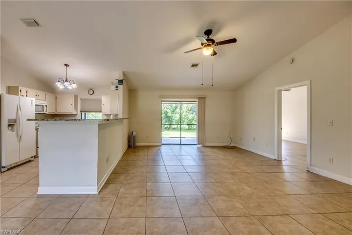 Living Room, Kitchen Open Door to Owners' Suite
