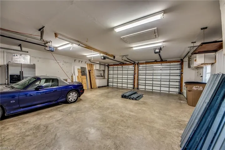 Huge Newer Garage w/ 3 doors, Refrigerator, Many cabinets & Work Stations. Large Floored Attic above.