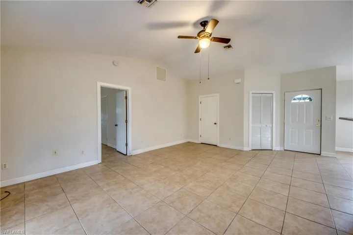 Living Room, Foyer. Door to Owners' Suite, Closed Door to Laundry Rm & Garage #1.