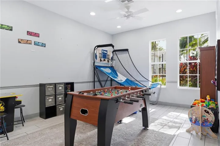 Recessed lighting, ceiling fan, crown molding, white tile flooring, and multiple windows