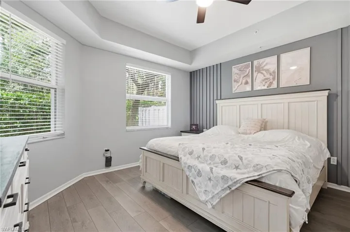 Wood-finish flooring, ceiling fan, Double doors and window with horizontal blinds