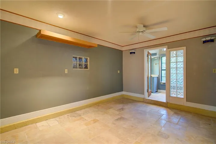 Spare room with stone tile flooring and ceiling fan