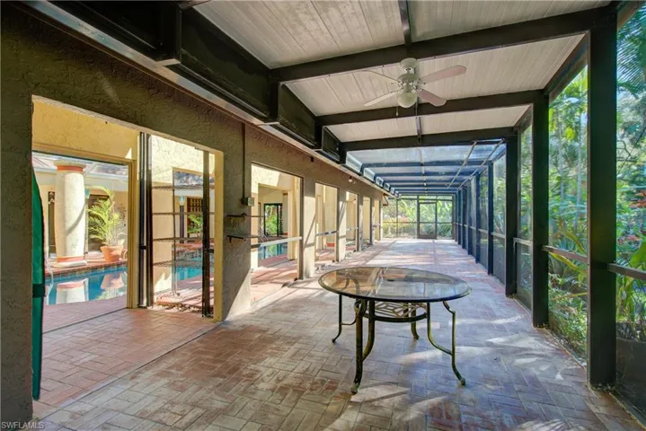 Sunroom featuring beam ceiling