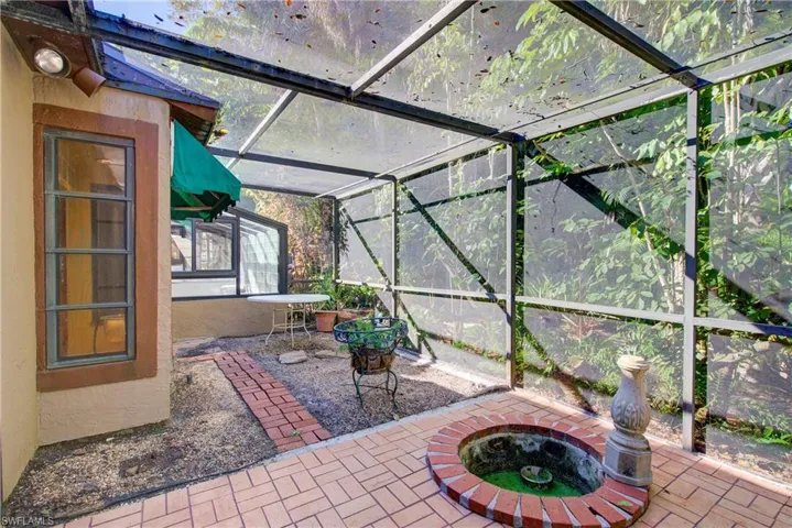 View of patio with a sunroom and glass enclosure