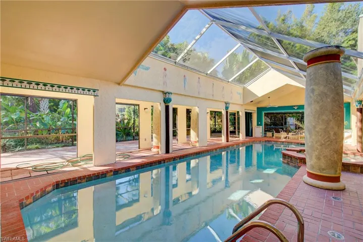 View of swimming pool with a pool, a lanai, a patio area, and a sunroom