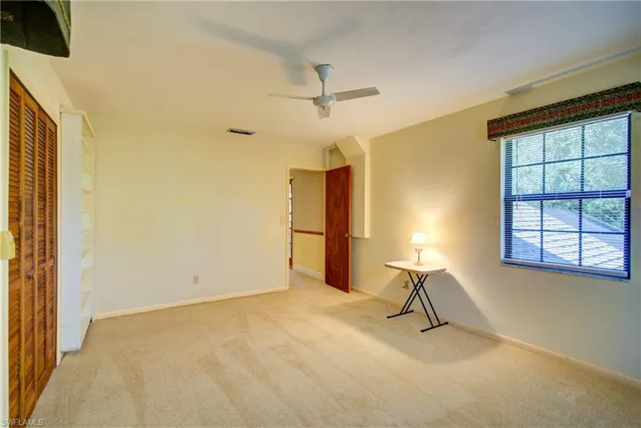Unfurnished bedroom featuring carpet, a ceiling fan, and a closet