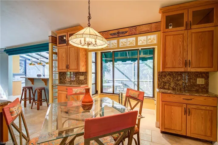 Dining area featuring stone tile floors and baseboards