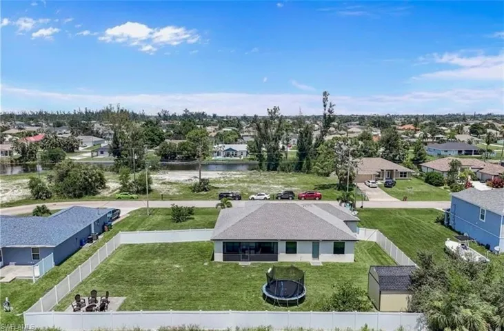 Aerial perspective of suburban area with a large body of water