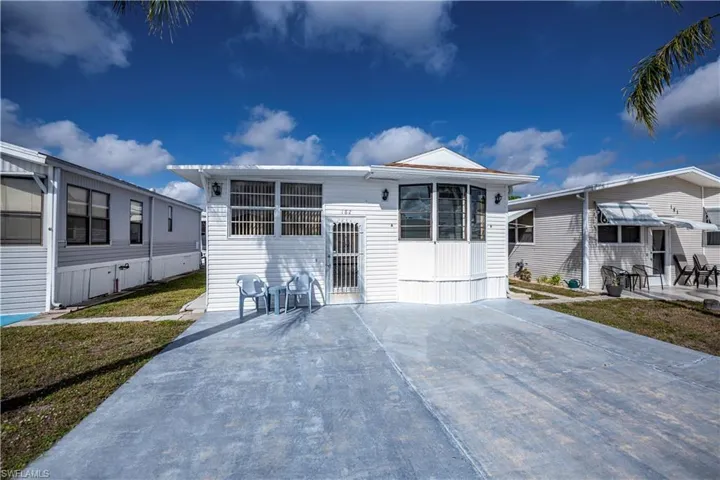 Manufactured / mobile home featuring a patio area and a front lawn