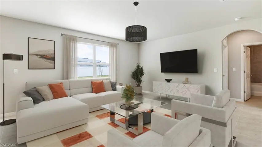Living room featuring arched walkways and light tile patterned floors