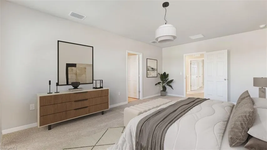 Bedroom featuring light colored carpet and baseboards