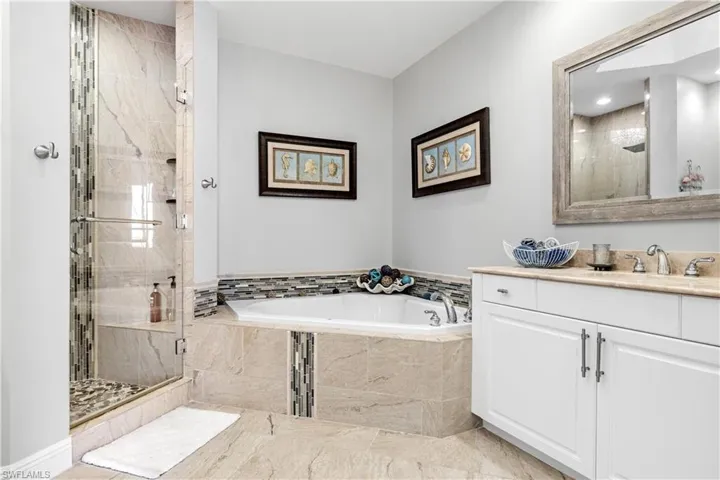 Bathroom featuring plus walk in shower and vanity