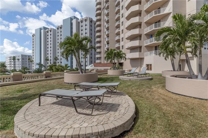 View of property's community courtyard featuring a yard and a patio area