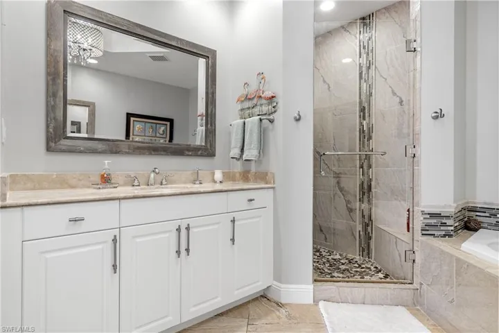 Bathroom featuring vanity and shower with separate bathtub