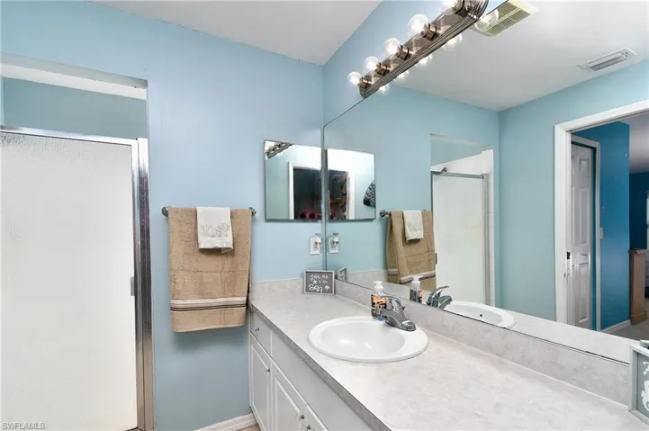 Bathroom featuring vanity and a stall shower