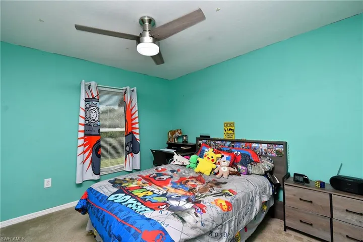 Bedroom with carpet and ceiling fan