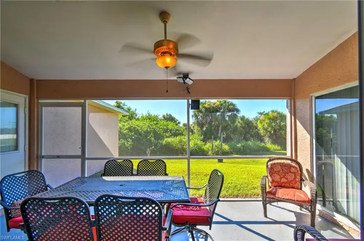 Sunroom featuring a ceiling fan and outdoor dining space