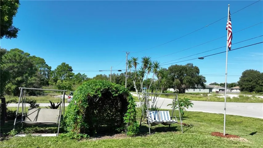 View of property's community featuring a yard