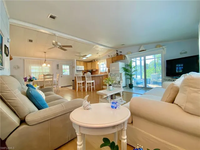 LIVING ROOM with light wood-type flooring and vaulted ceiling