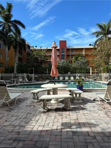 Community pool with a patio