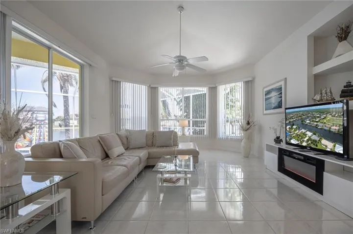 Living room featuring ceiling fan and light tile patterned floors