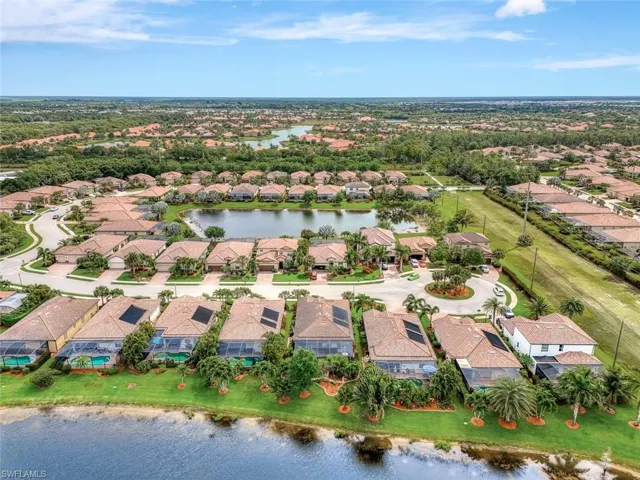 Aerial perspective of suburban area featuring a large body of water