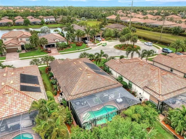 Aerial view of residential area with a pool area and a nearby body of water