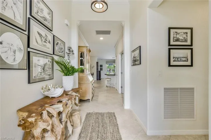 Corridor featuring light tile patterned flooring, ornamental molding, and recessed lighting