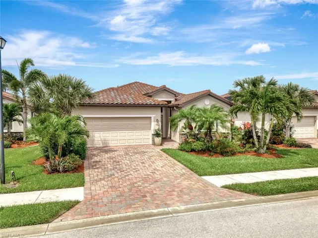 Mediterranean / spanish-style house featuring stucco siding, decorative driveway, a tiled roof, and a garage