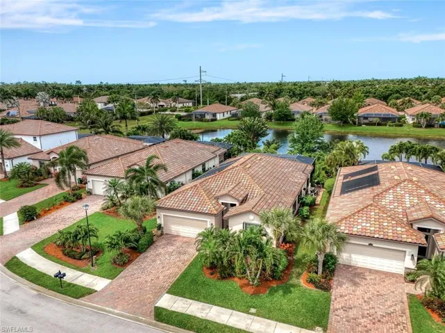 Aerial perspective of suburban area featuring a nearby body of water