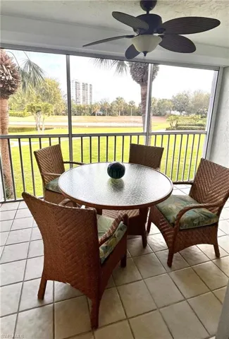 Sunroom featuring ceiling fan, outdoor dining area, and plenty of natural light