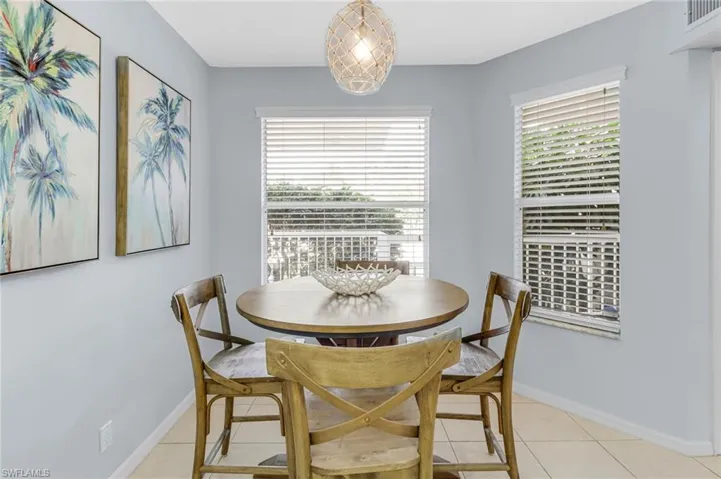 Dining space featuring light tile patterned flooring and baseboards