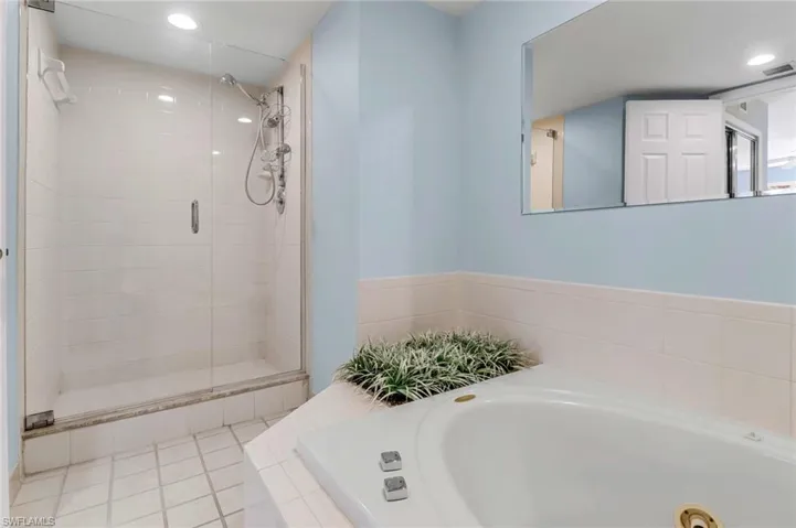 Full bath with a shower stall, a bath, and recessed lighting