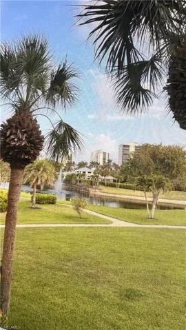 View of community featuring a water view and a yard