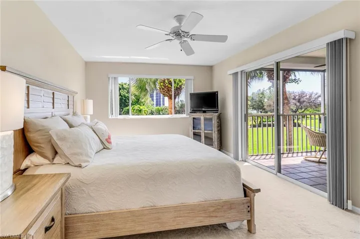Carpeted bedroom featuring access to exterior, ceiling fan, and baseboards