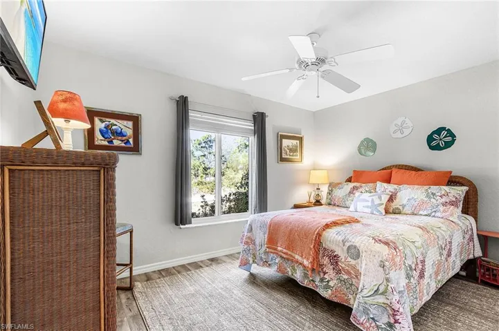 Bedroom with light wood-style flooring and a ceiling fan