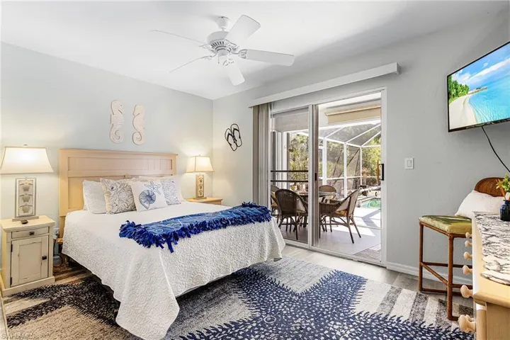 Bedroom featuring a sunroom, light wood-style flooring, access to outside, and ceiling fan