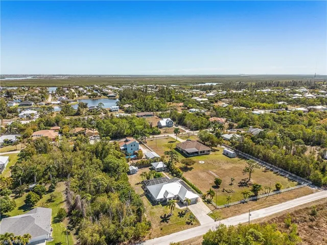 Aerial view of residential area featuring a large body of water