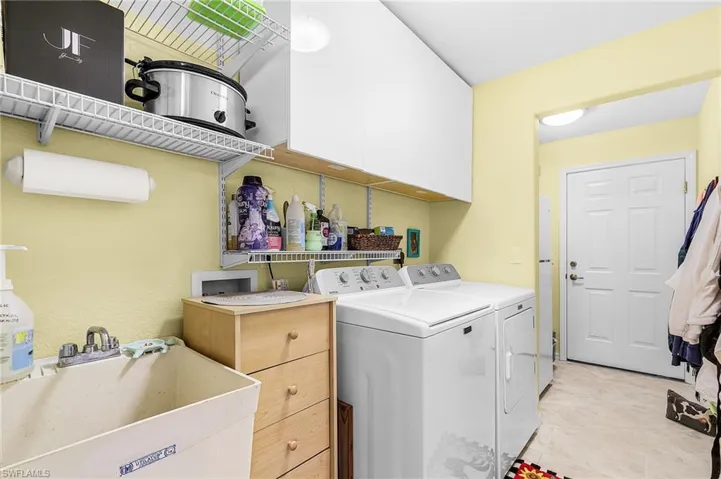 Laundry room with cabinet space and washing machine and dryer