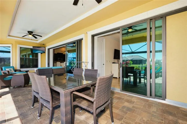 View of patio featuring outdoor dining space and a ceiling fan