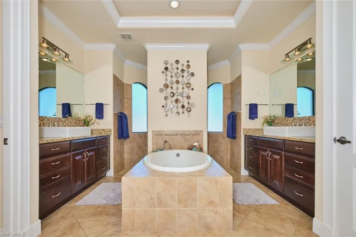 Full bath featuring visible vents, a walk in shower, crown molding, tile patterned flooring, and a bath