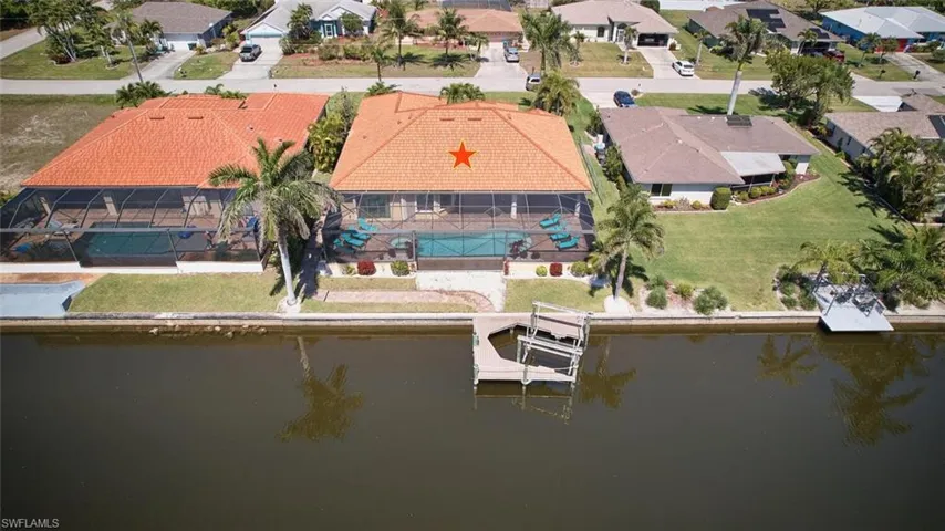 Birds eye view of property featuring a residential view and a water view