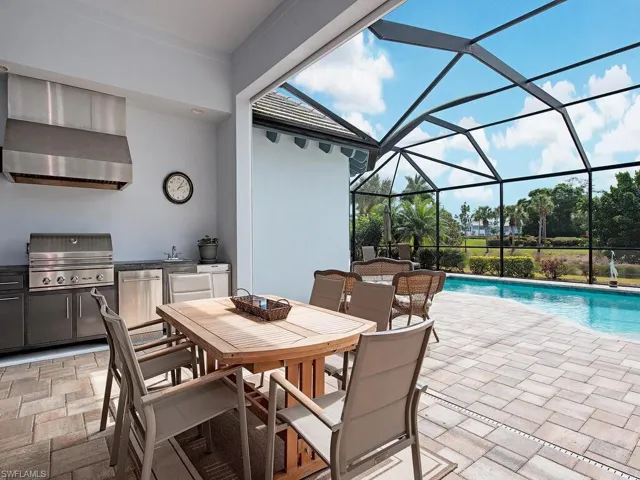 Dining area adjacent to the summer kitchen in the covered lanai.
